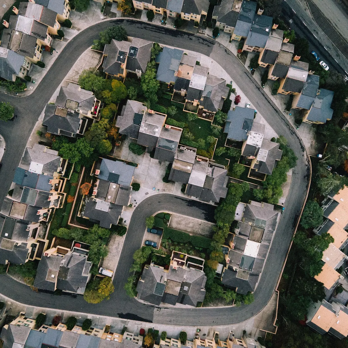 Aerial view of a housing area with curving streets and gardens