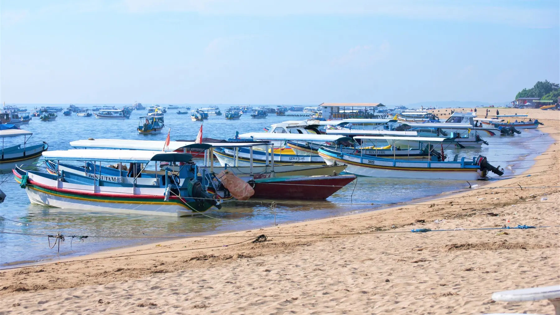Colourful fishing boats on a sandy beach on the north coast of Bali